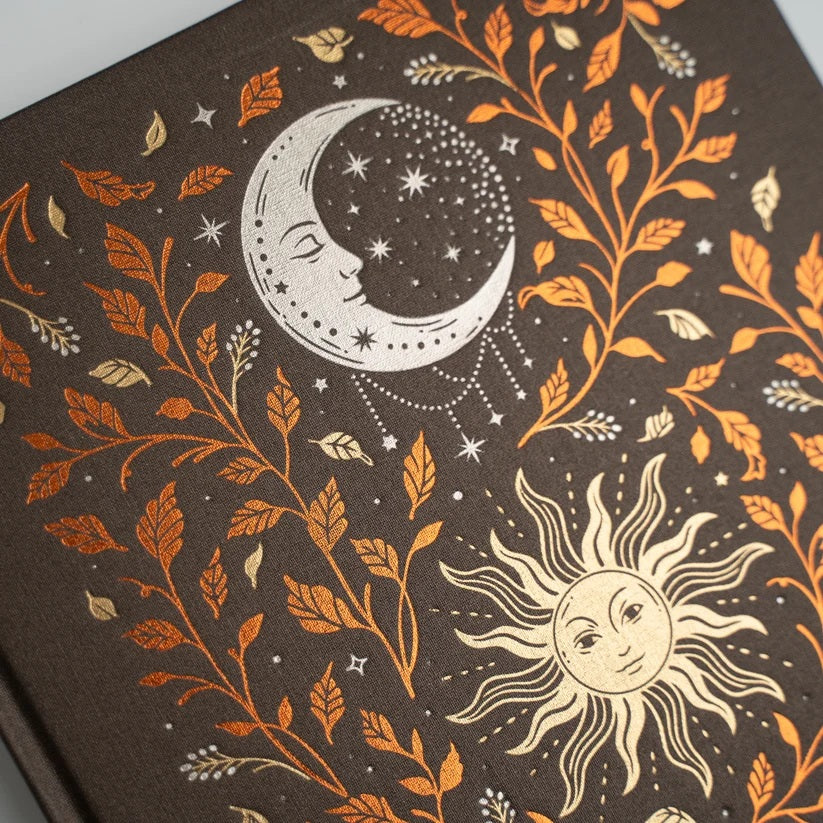 Close view of the Harvest Moon Notebook sun, moon, and autumn foil details
