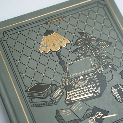 Close view of The Writer’s Desk Notebook gold foil cover illustration