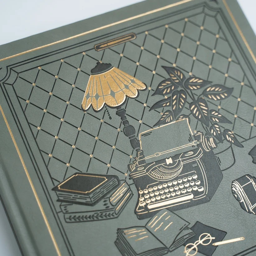 Close view of The Writer’s Desk Notebook gold foil cover illustration